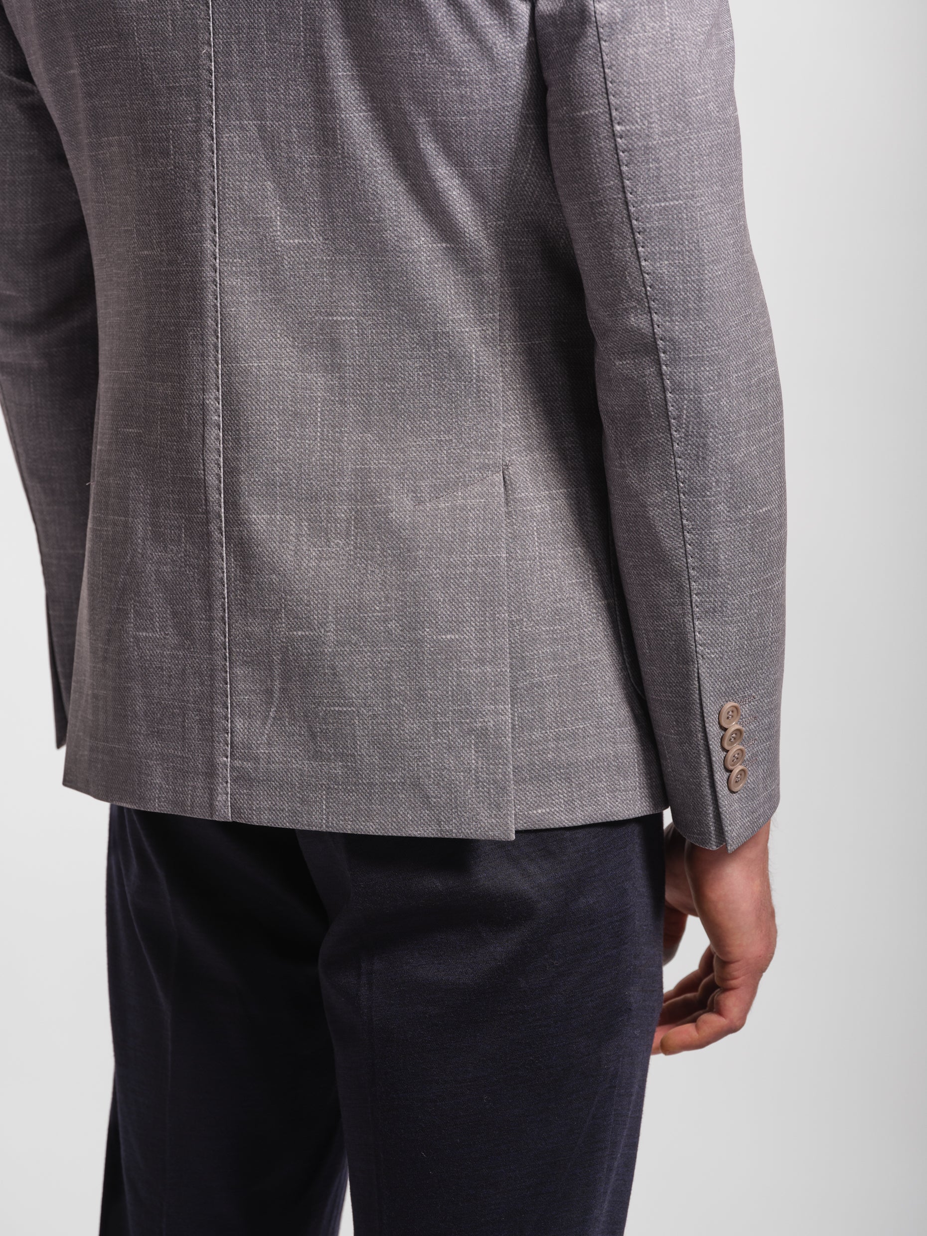Gray suit jacket with double vents and topstiching