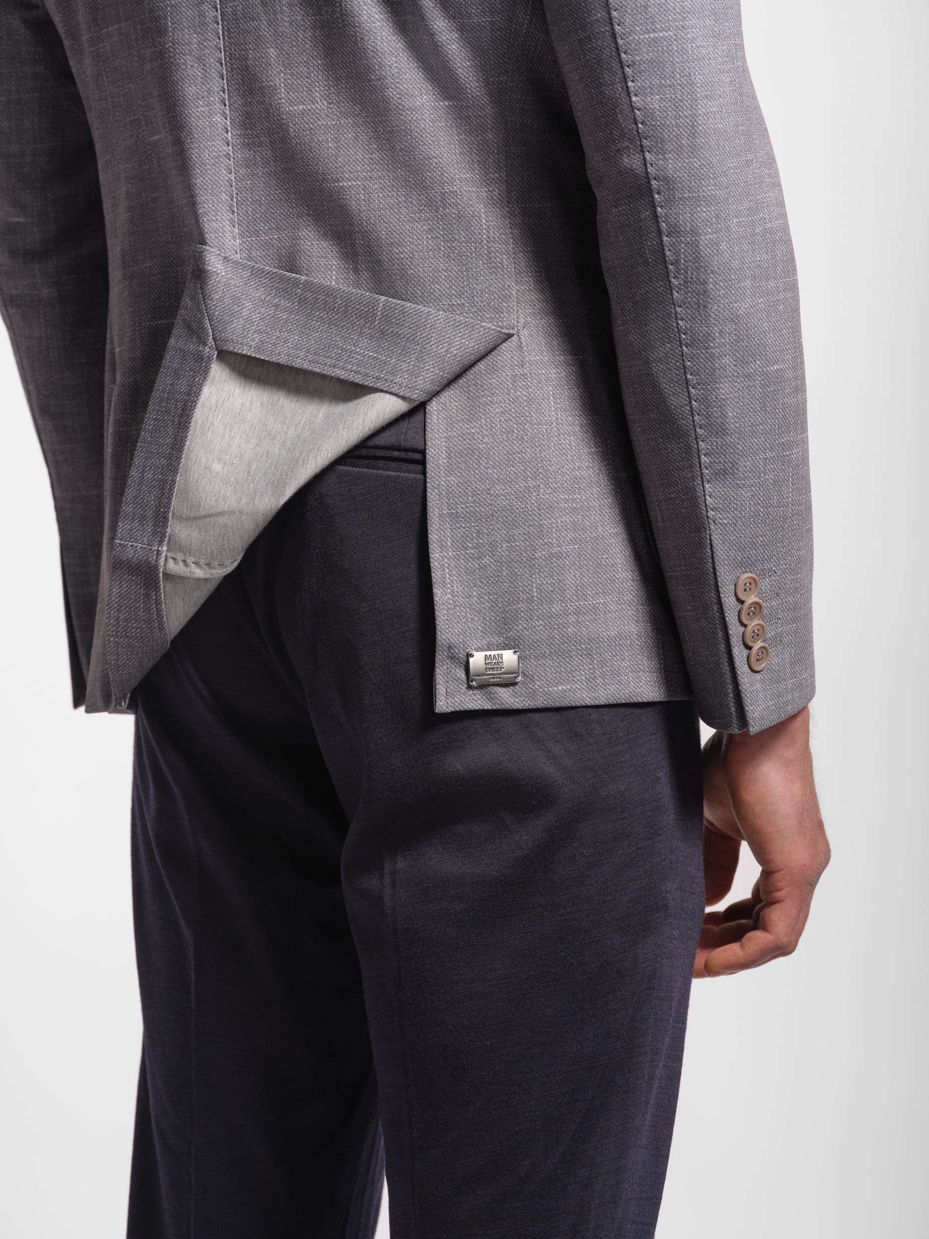 Gray suit jacket with top stitch and metal logo and stretch jersey fabric blazer