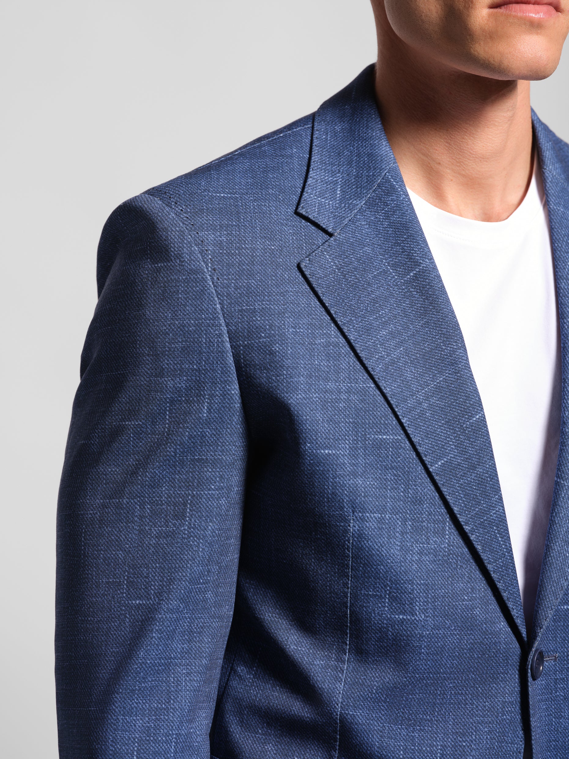 close up Man in a stretchy, comfortable Navy Jerseyblazer jacket over a white t-shirt with navy pants wearing Man Wears Sheep and showing wide notch lapel