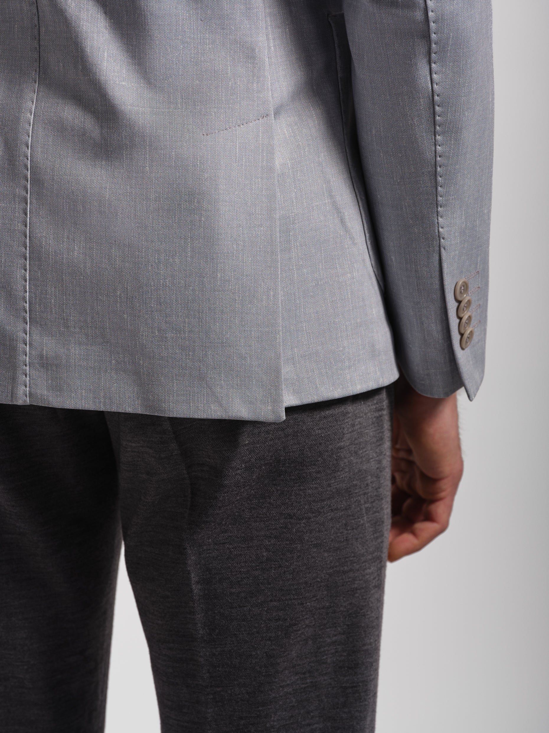 Gray blazer a stretch and comfortable jacket and pants on a plain background and double vents with top stiching