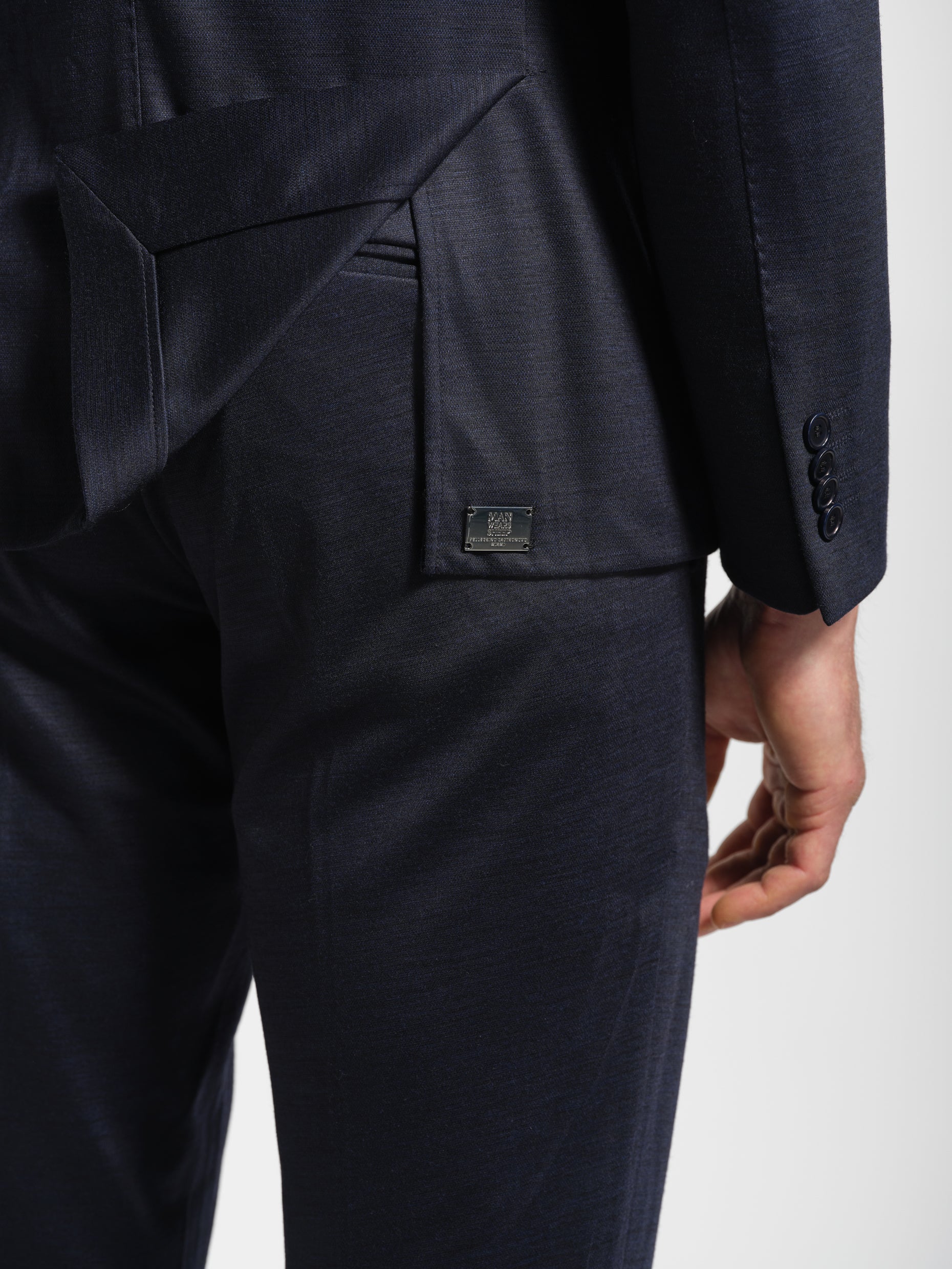 Navy suit with a close-up of the pants metal label