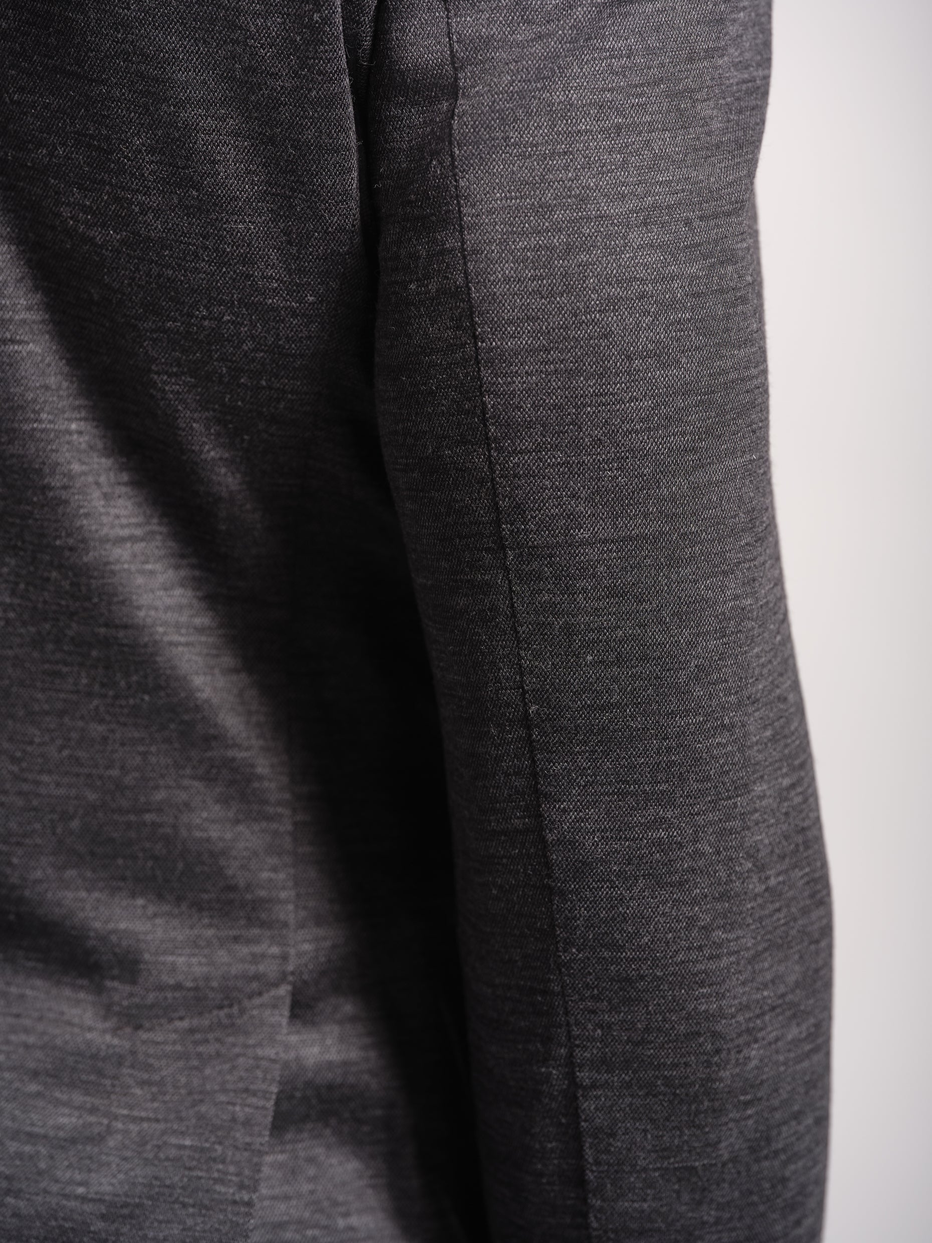 Close-up of Charcoal grey jersey stretch suit top stiching