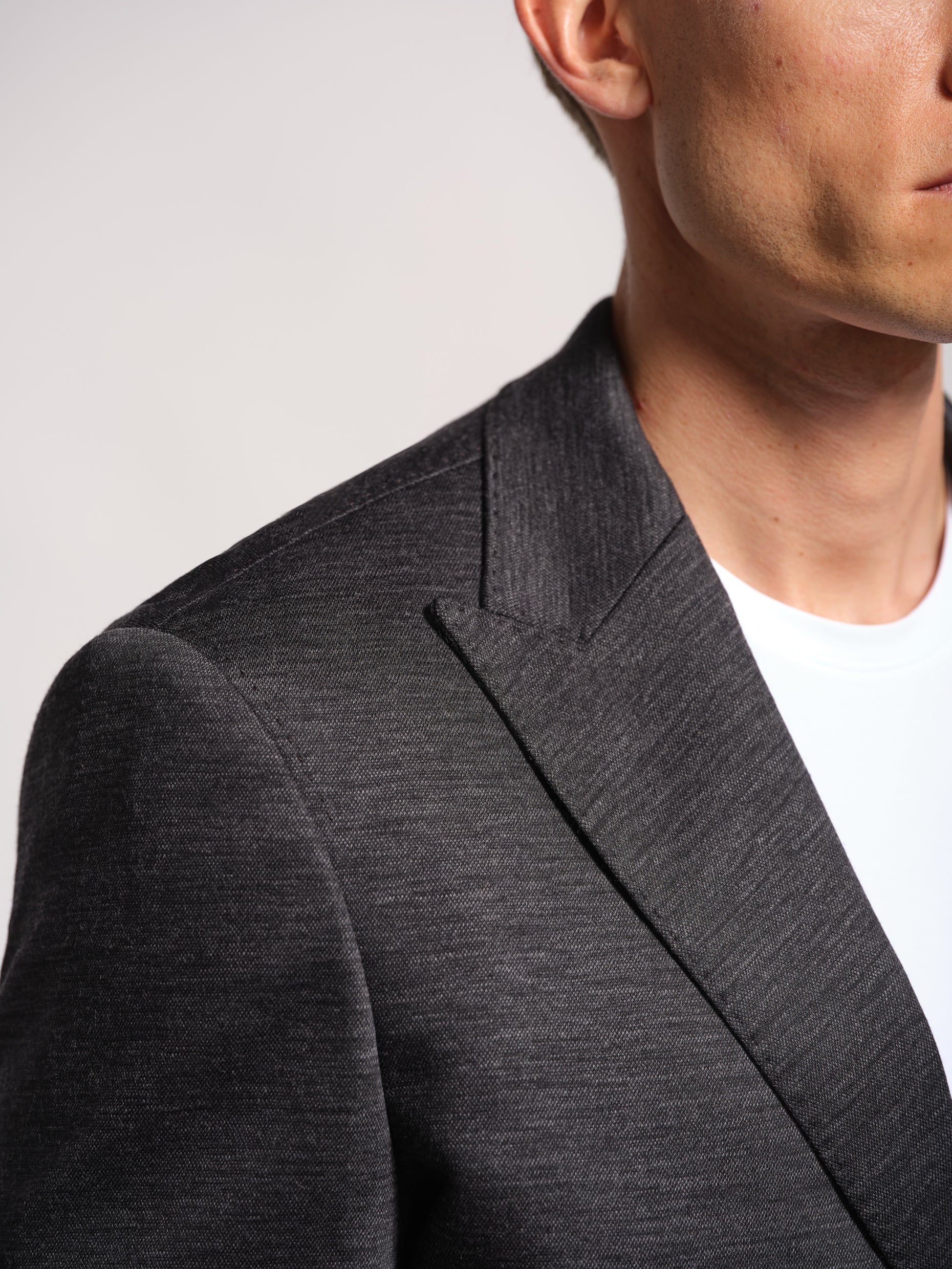 Charcoal grey jersey stretch suit front view peak lapel