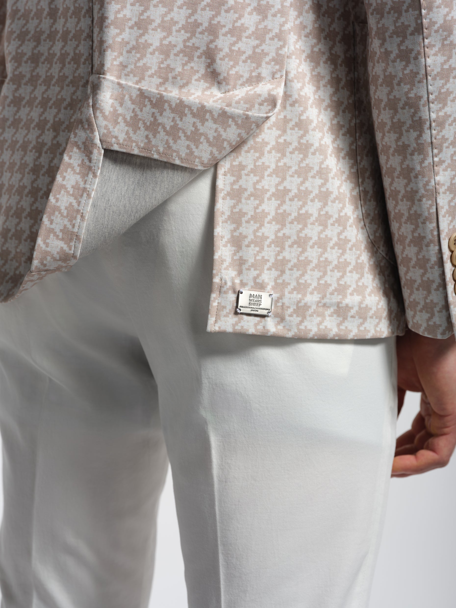 Close-up of a patterned jacket man wears sheep logo