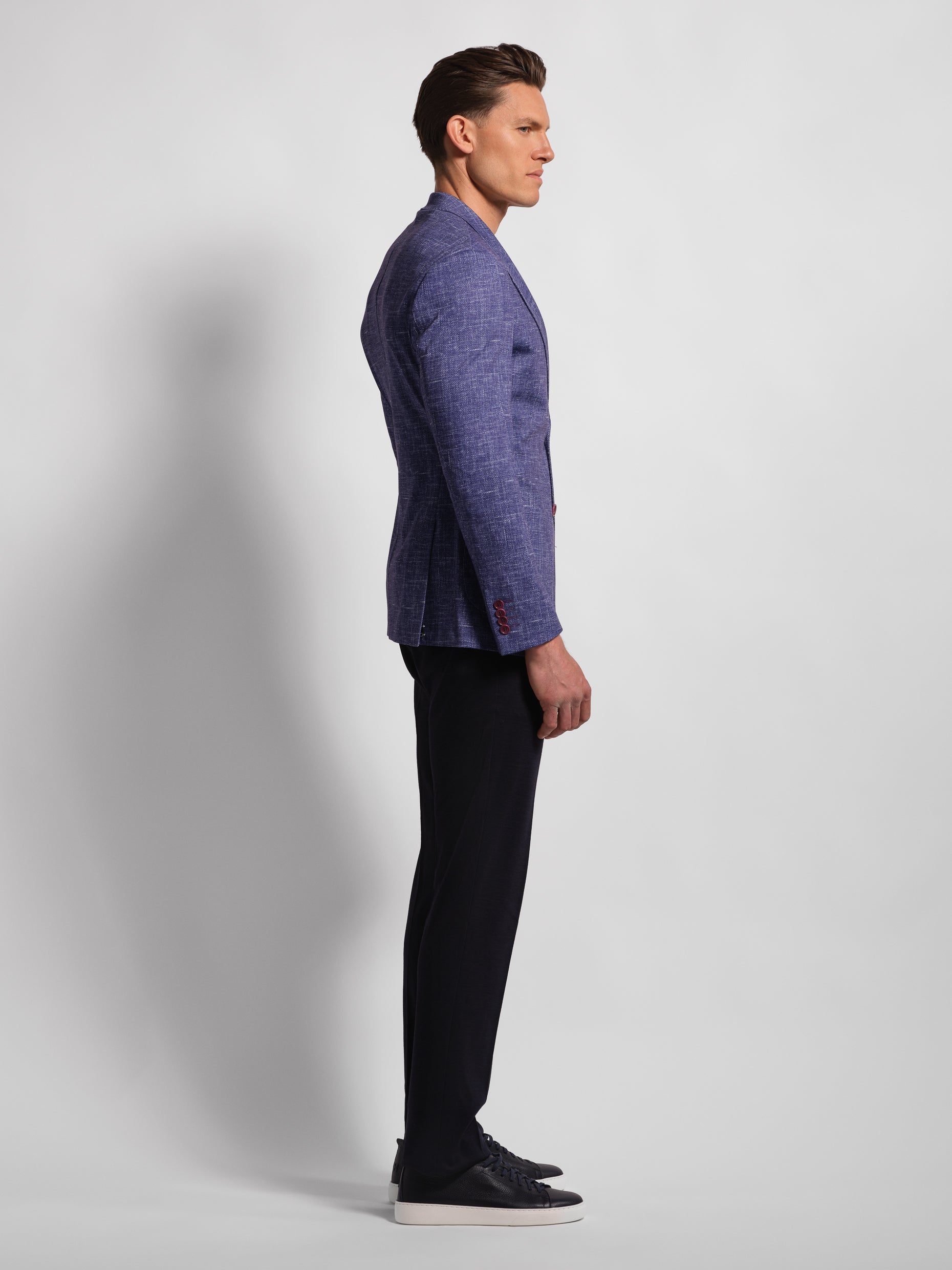 Man profile wearing a stretch jersey purple blazer over a white shirt and Navy pants with wide notch lapels and patch pockets model