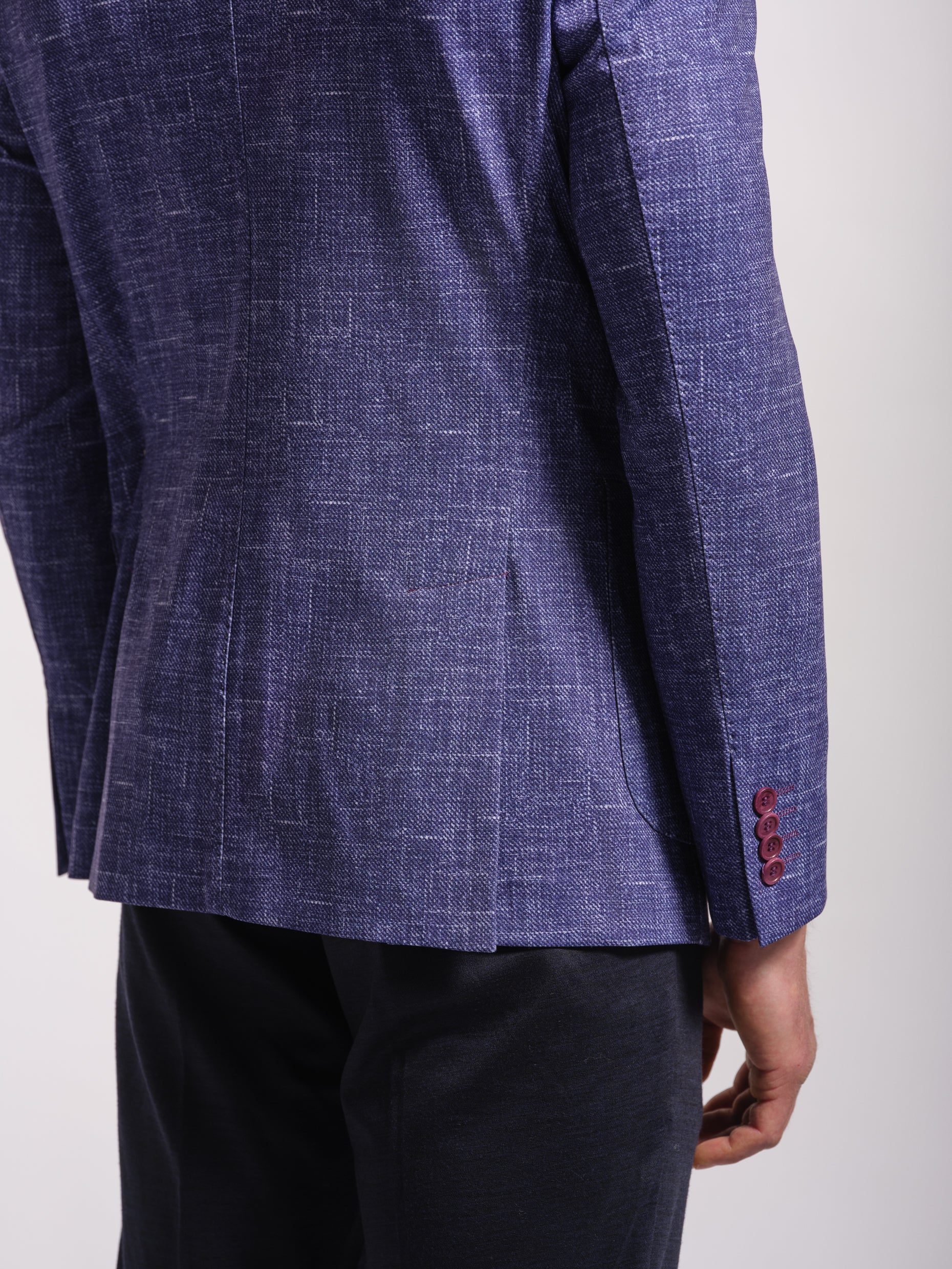 back Close-up ofMan wearing a stretch jersey purple blazer over a white shirt and Navy pants with wide notch lapels and patch pockets model