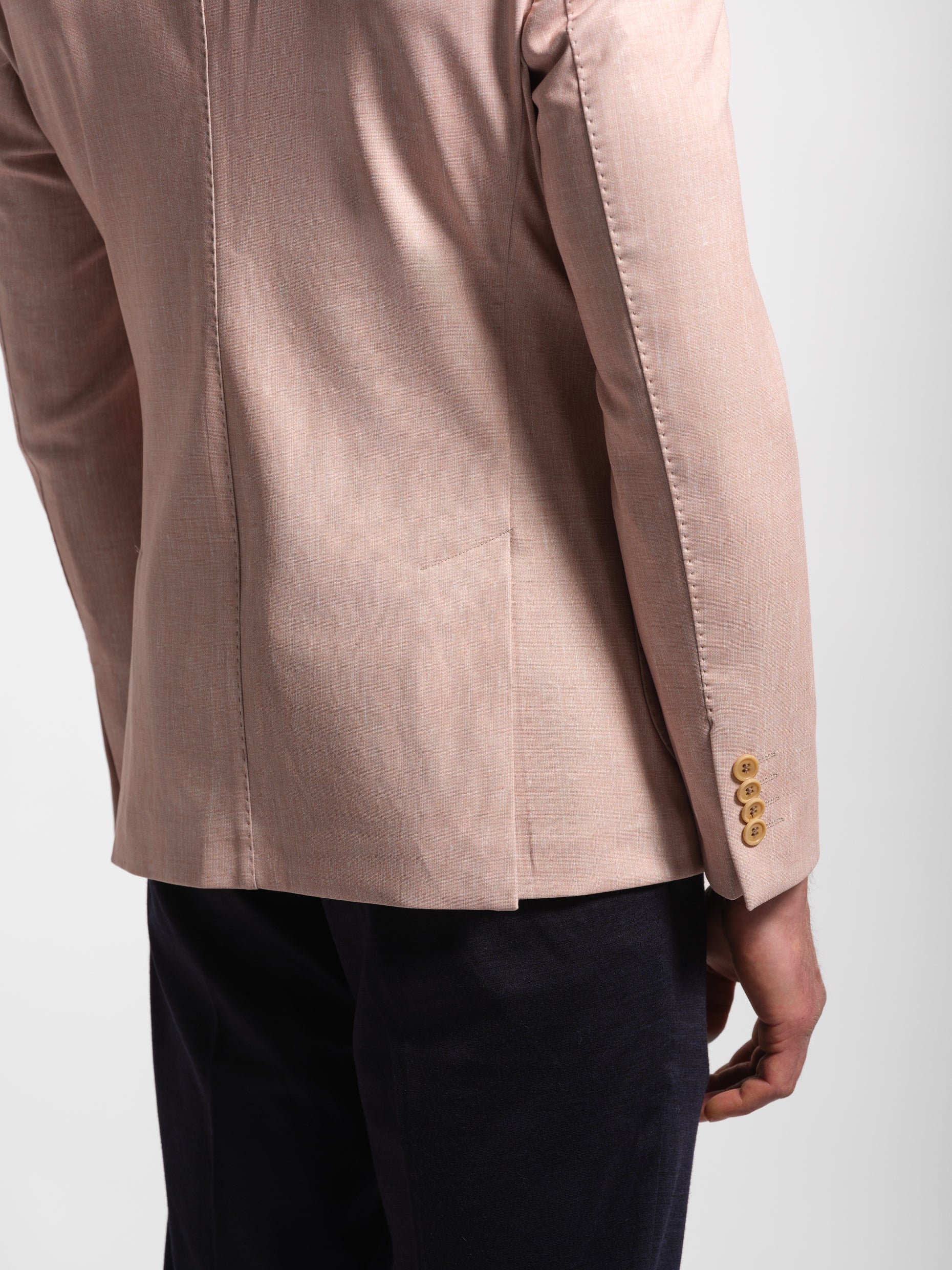 light coral jacket with 4 buttons with topstiches and double vents on a white background