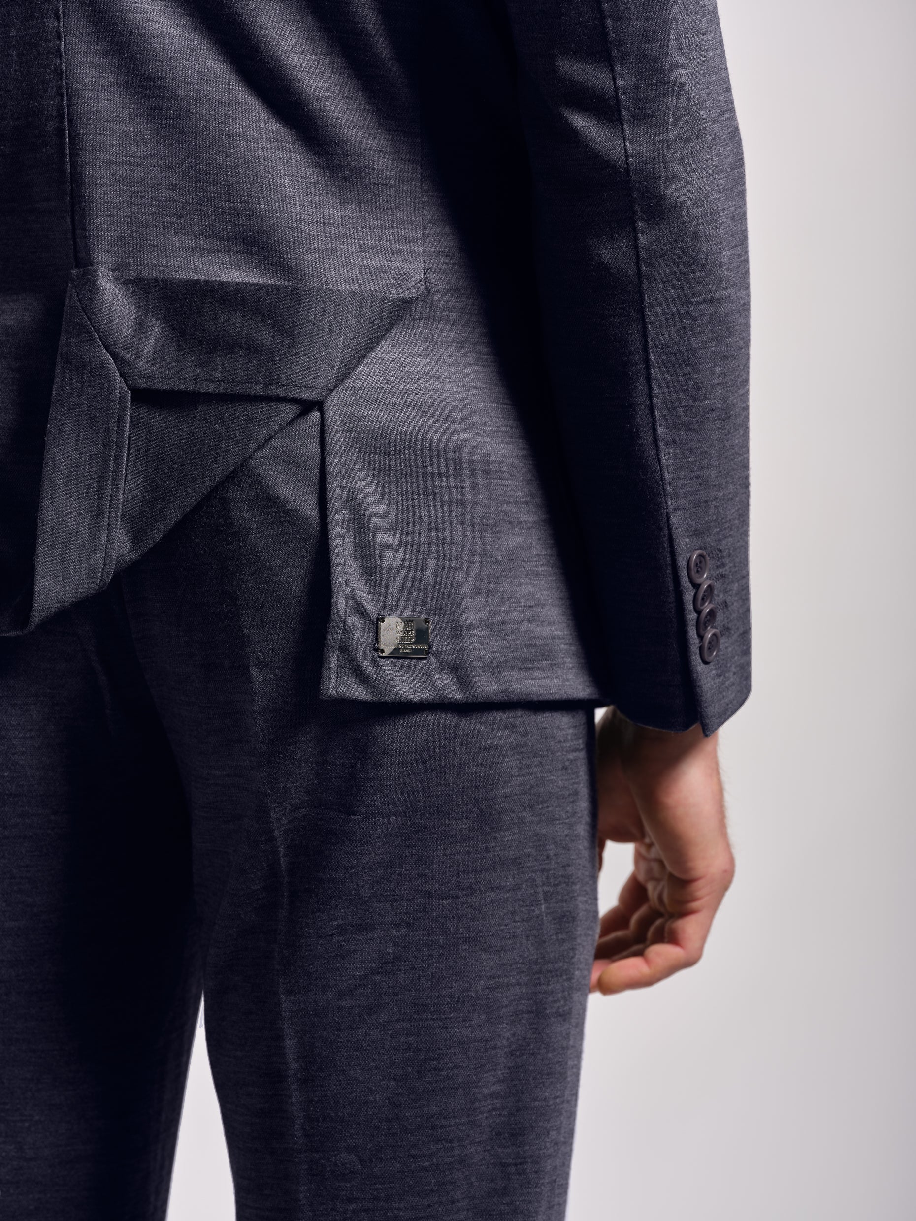 Blue suit with metal label man wears sheep