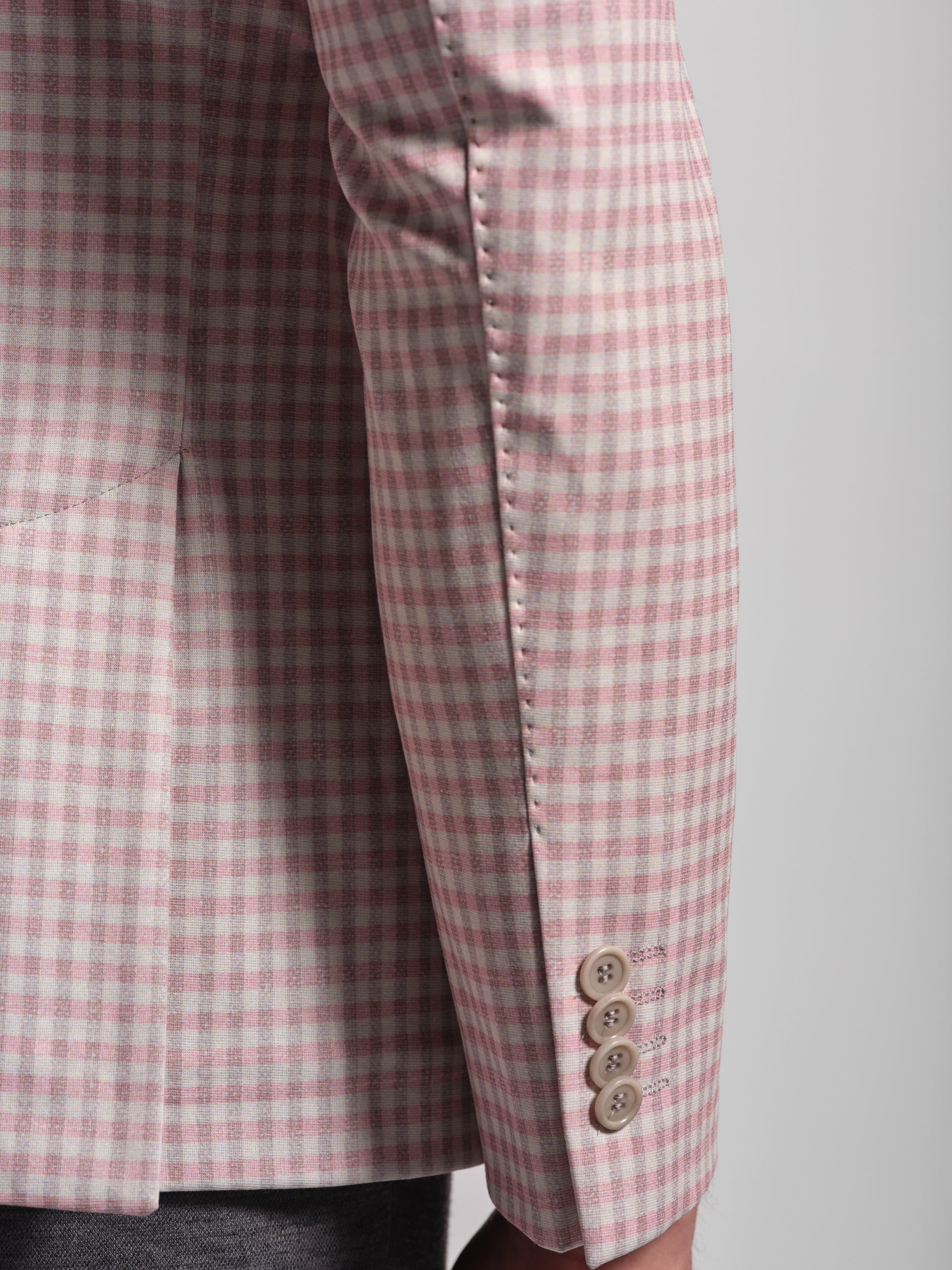 Close-up of a pink and white checkered sport jacket in pick stick
