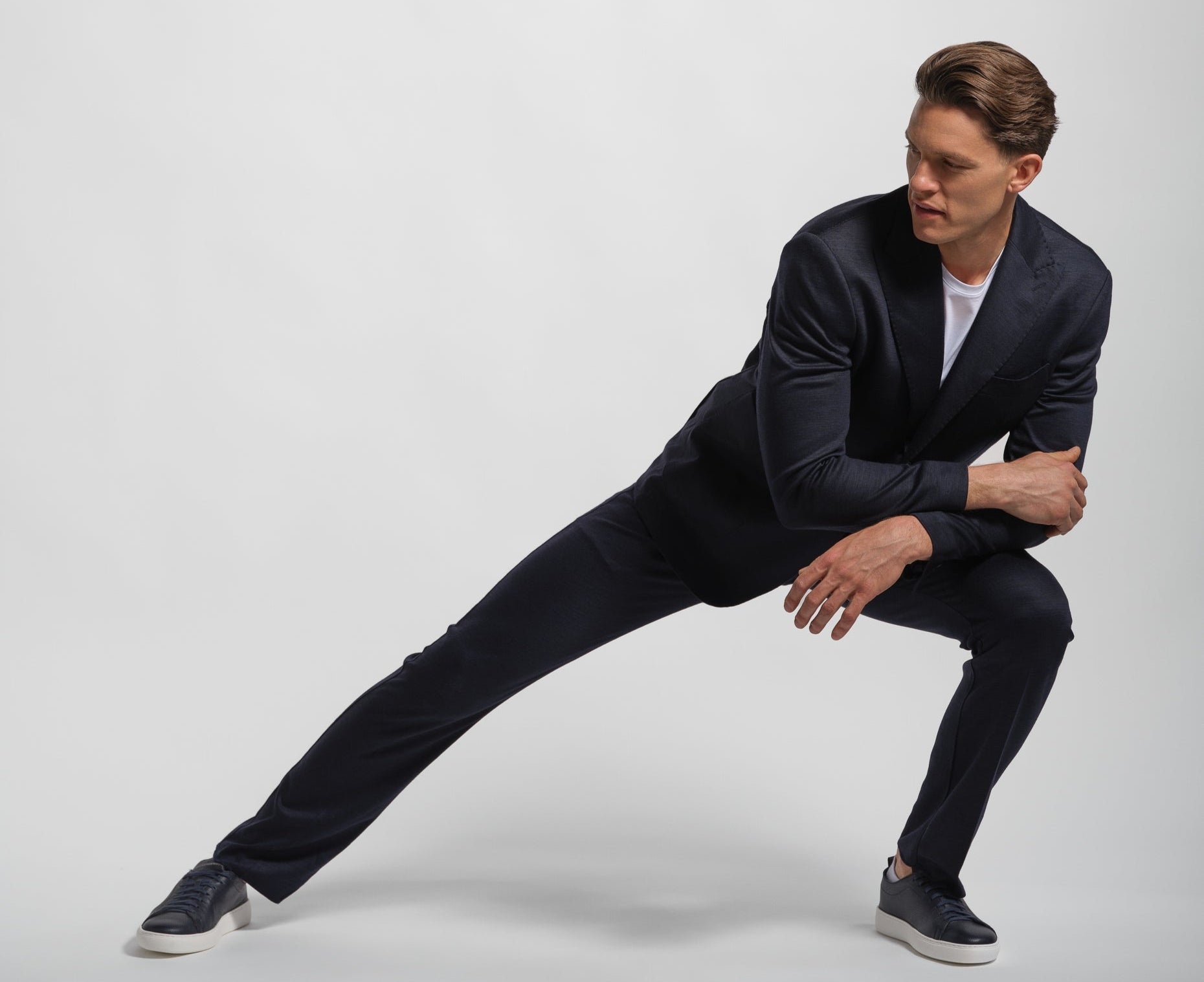 Man wearing a black jersey stretch suit stretching