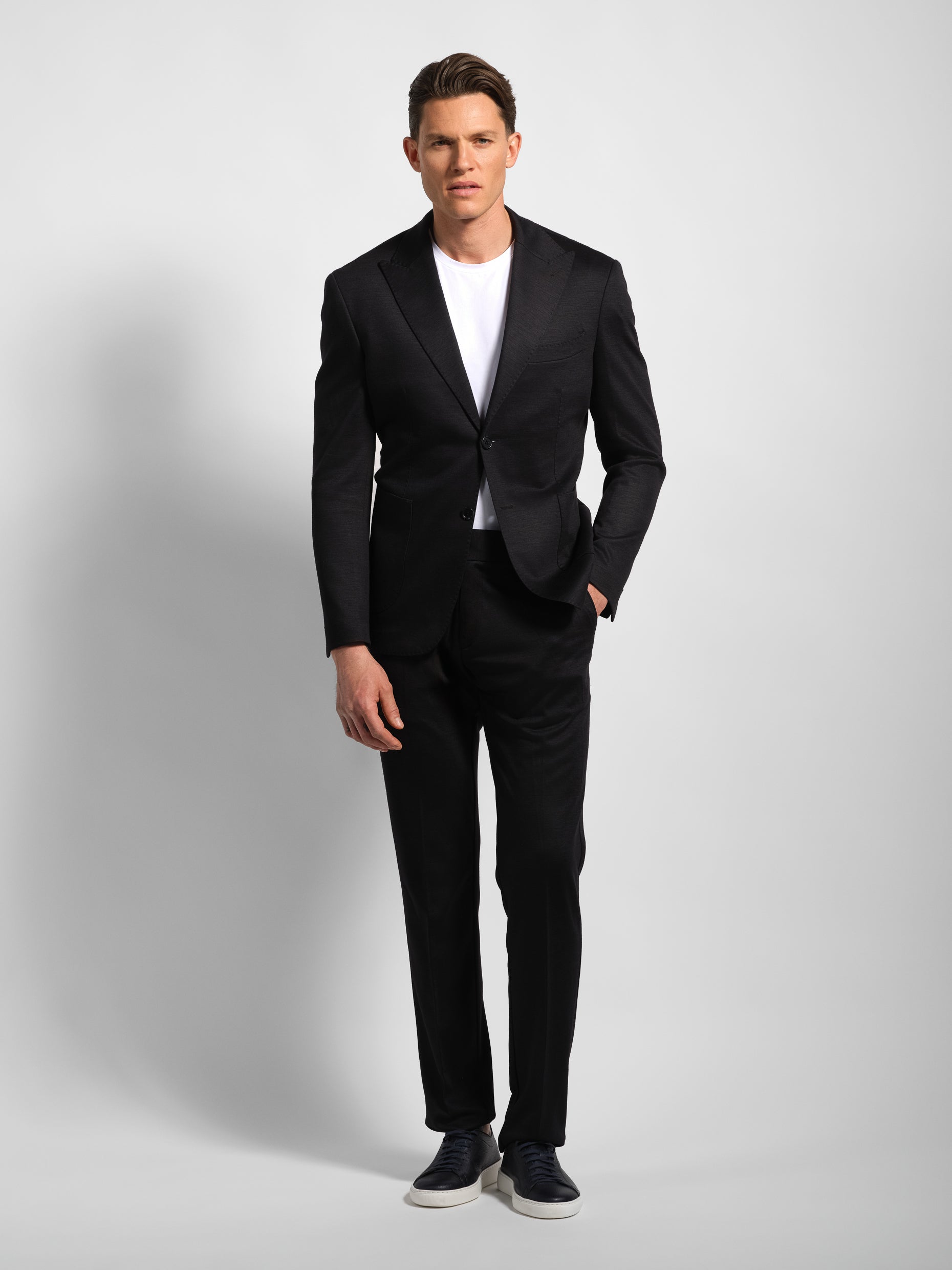Man wearing a black jersey stretch suit front view