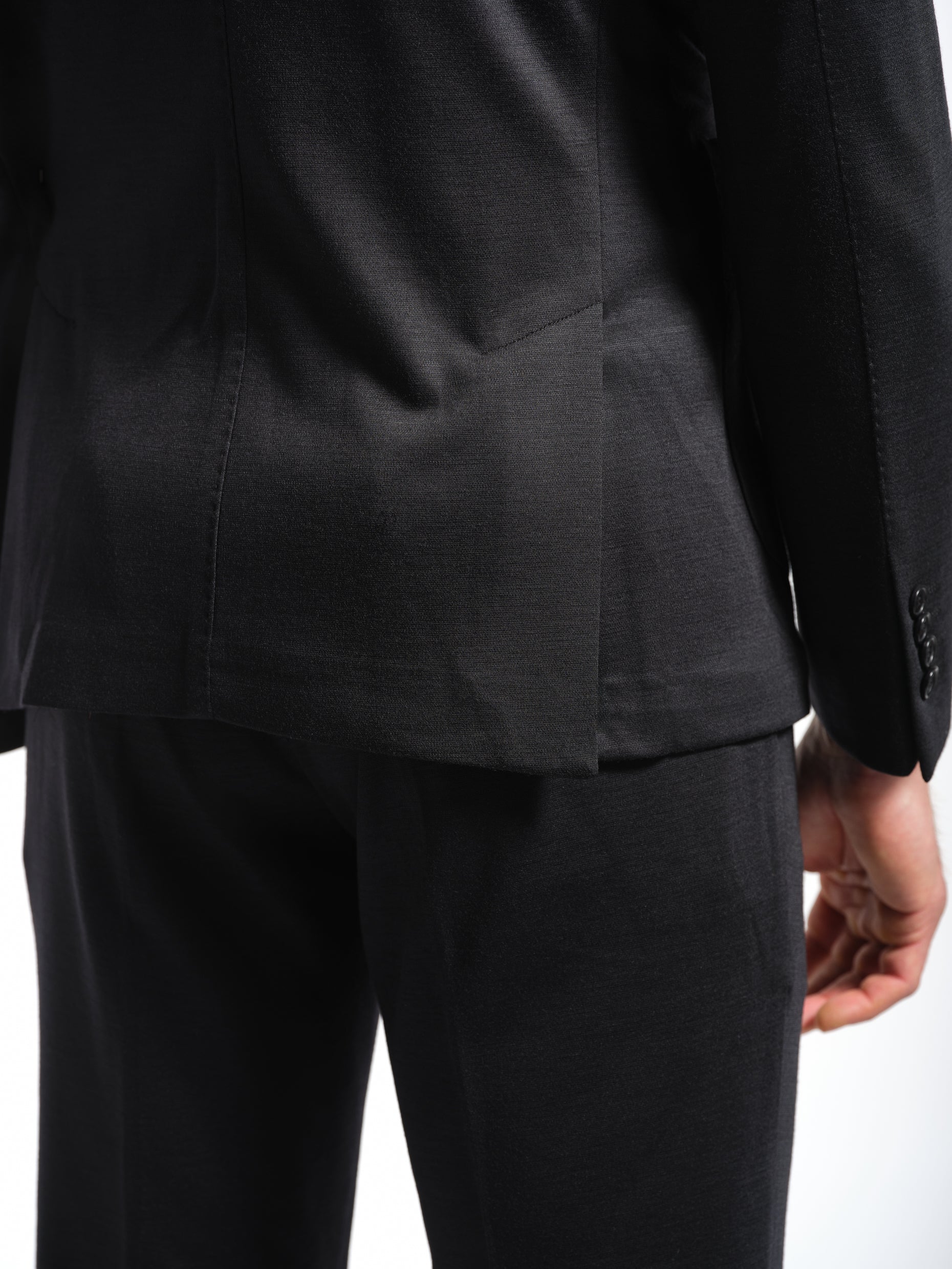 Man wearing a black jersey stretch suit double vents