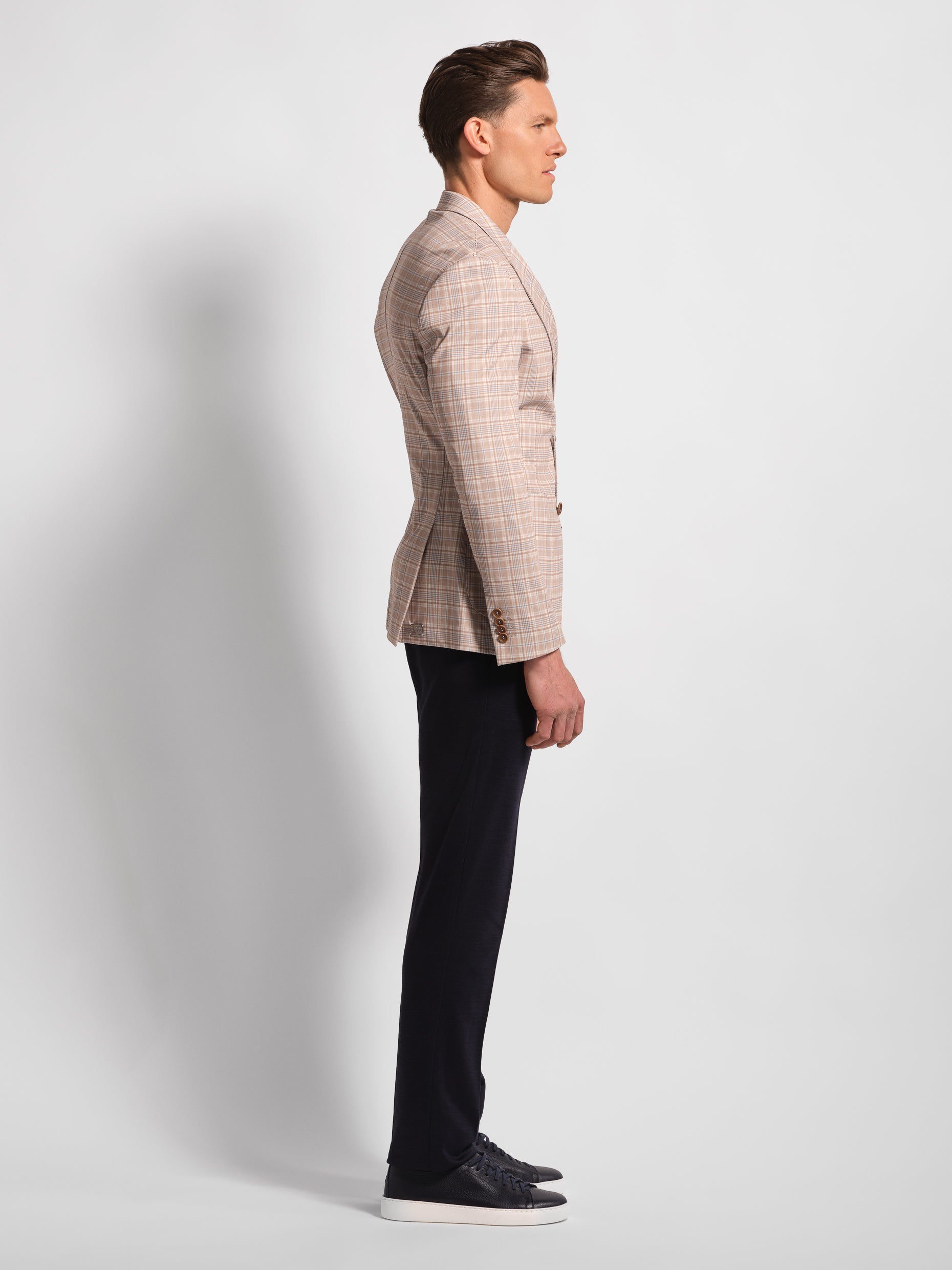 side view of man wide check multi-colored jersey blazer navy pants 