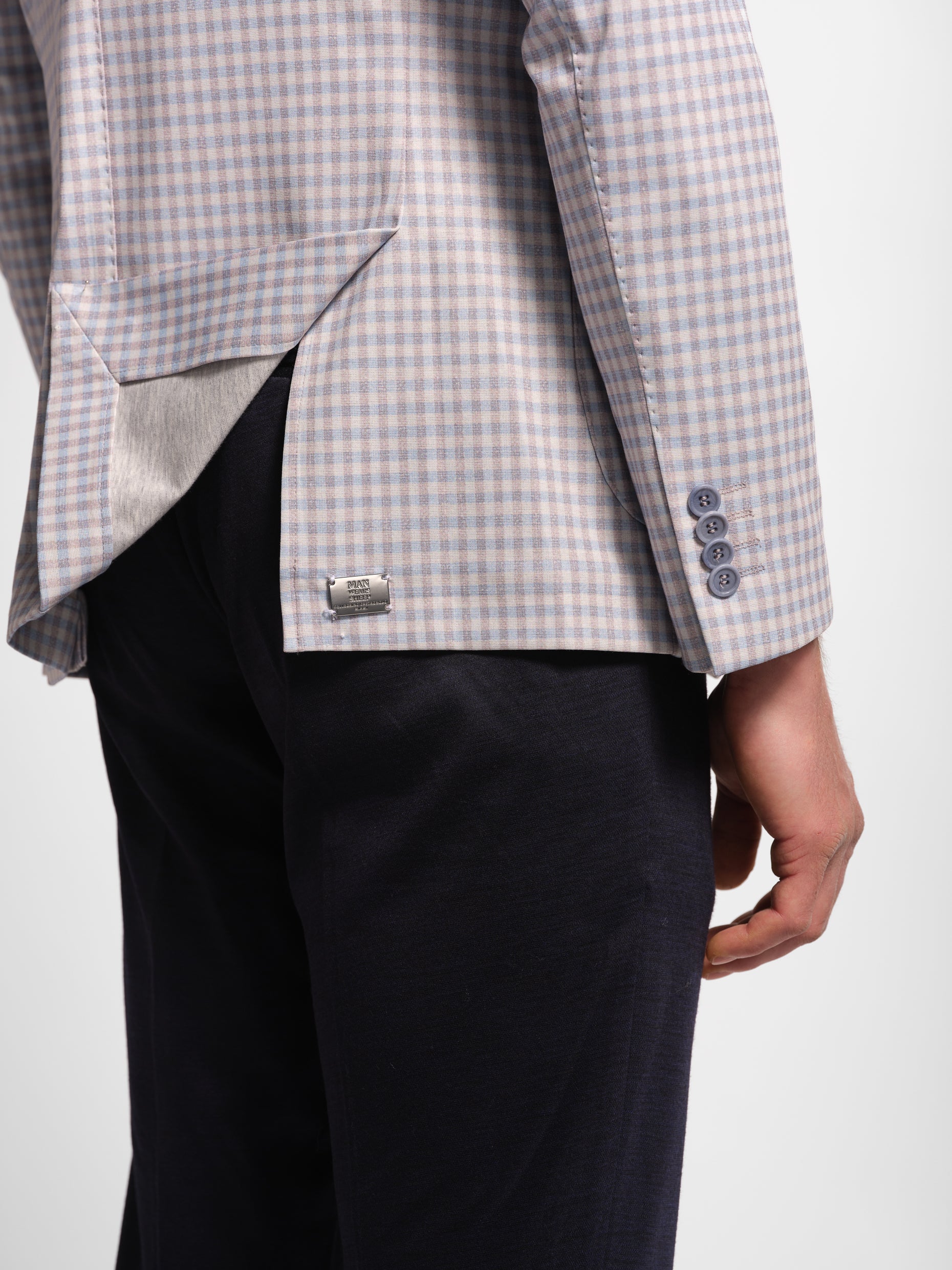 Gray checkered blazer with Navy pants on a manwearssheep logo