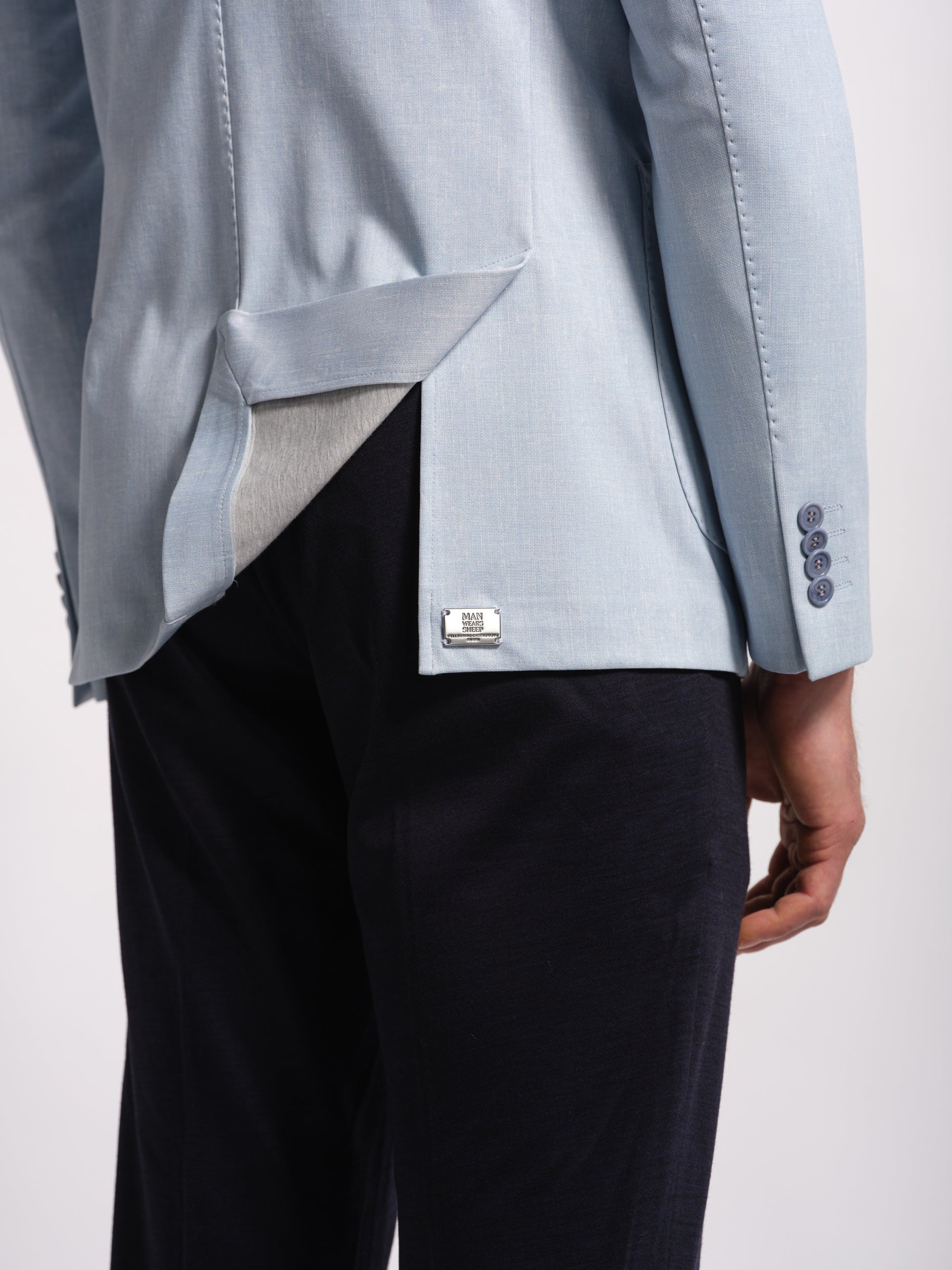 Light blue blazer with a Metal detail on a side vents , white background