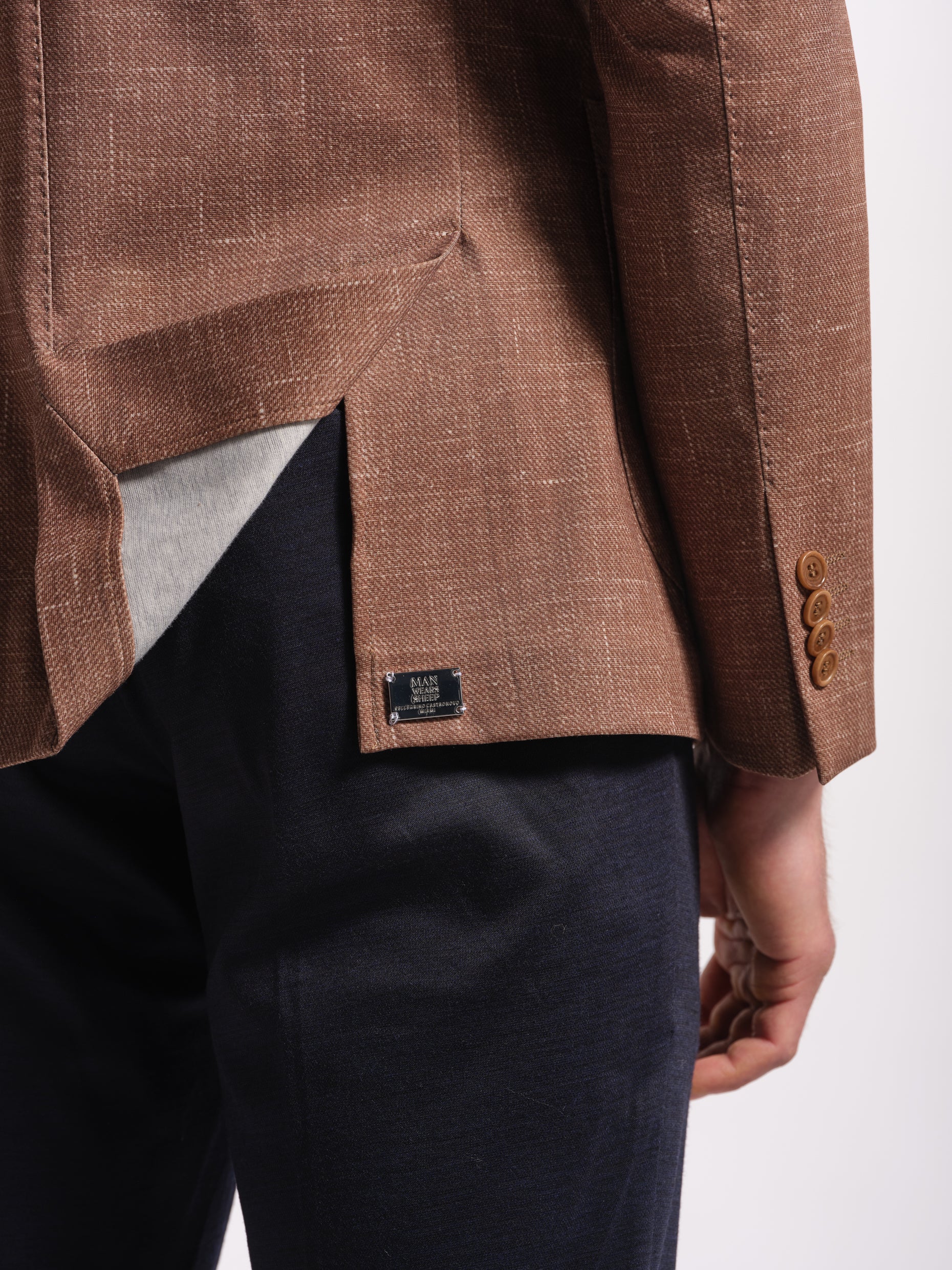 Brown blazer top stich  with four sleeve buttons on a white background