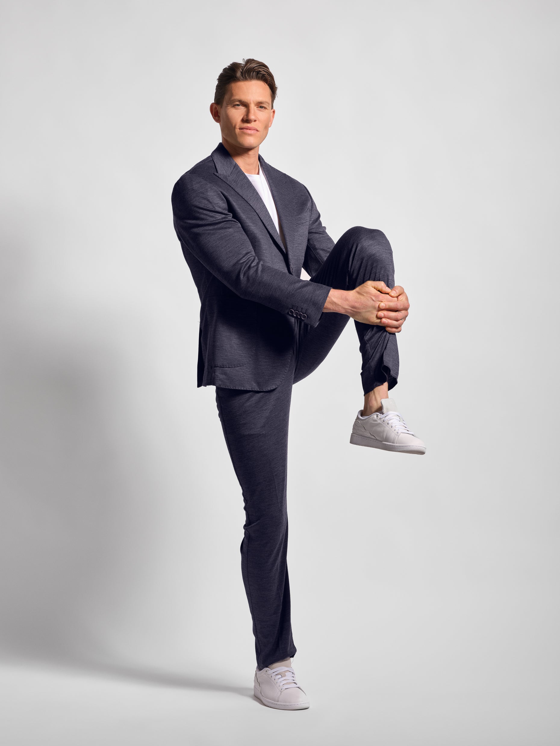 Navy jersey stretch suit  man stretching in them